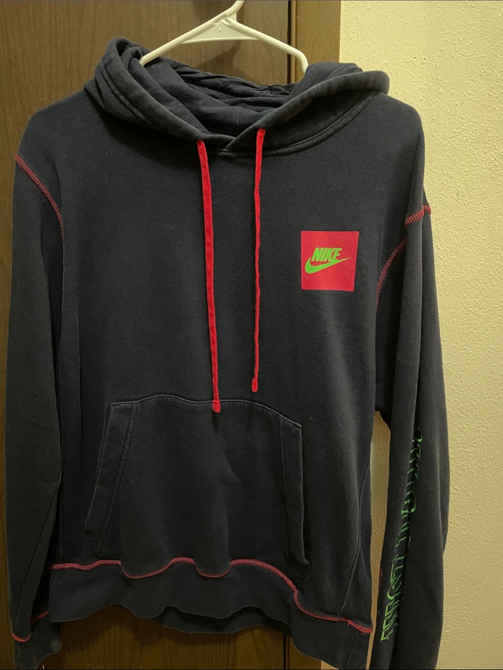 Nike Men’s navy blue Hoodie with Red Drawstrings and Green Logo